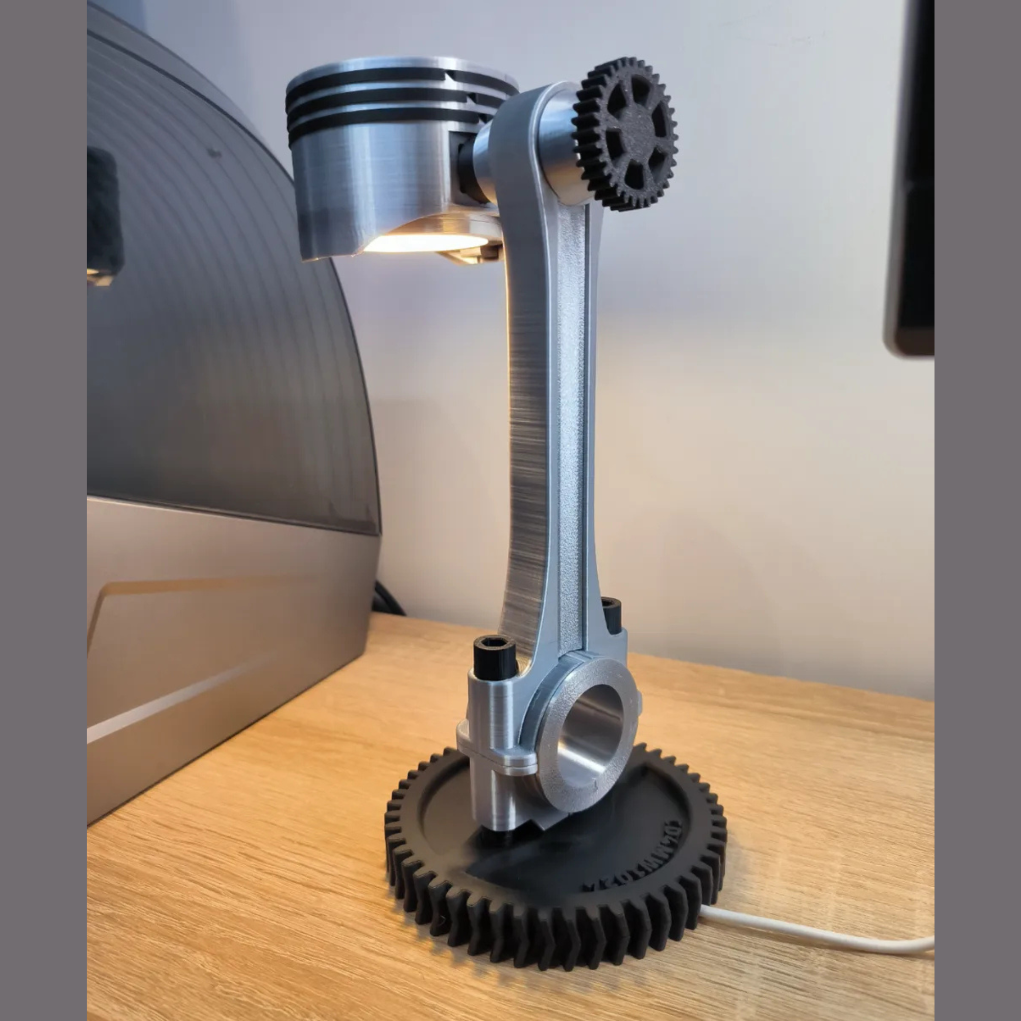 Metallic lamp designed with mechanical components on a wooden surface