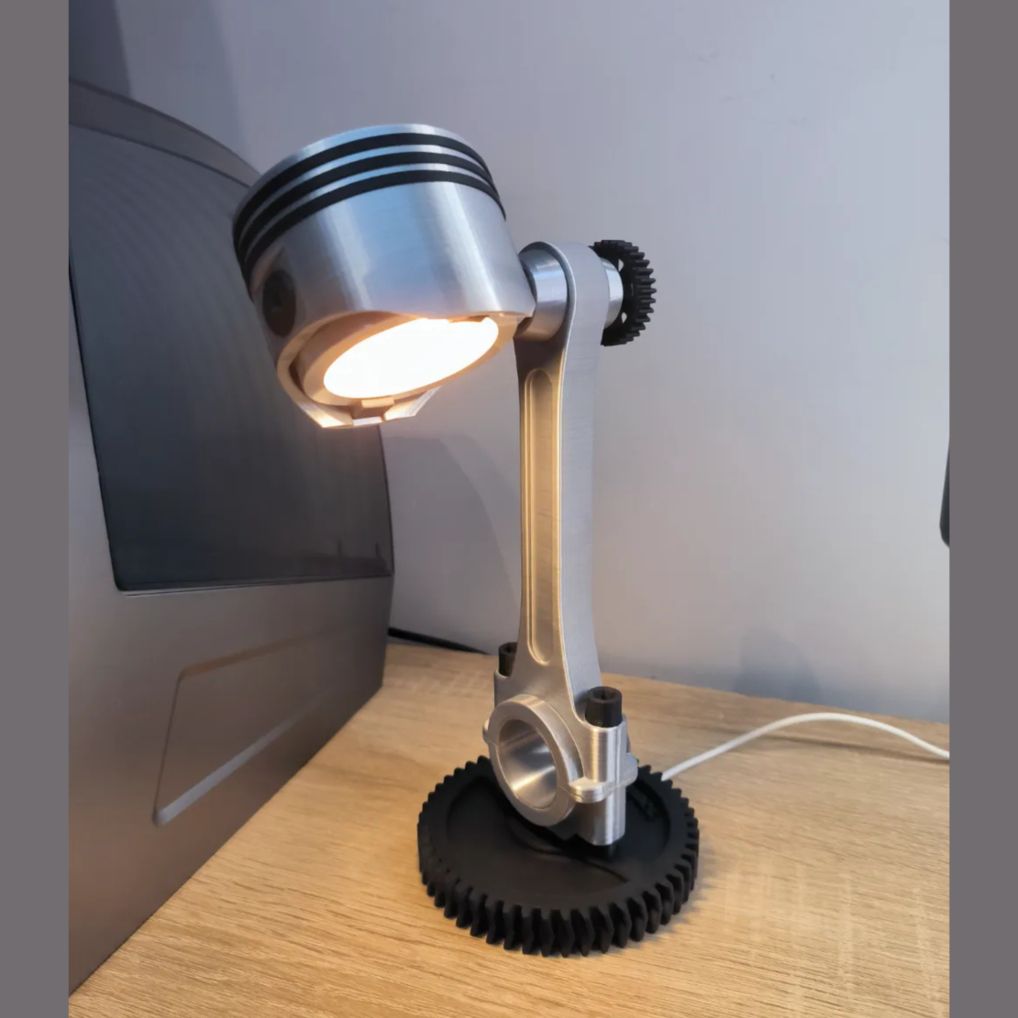 Modern desk lamp with gear design on a wooden surface