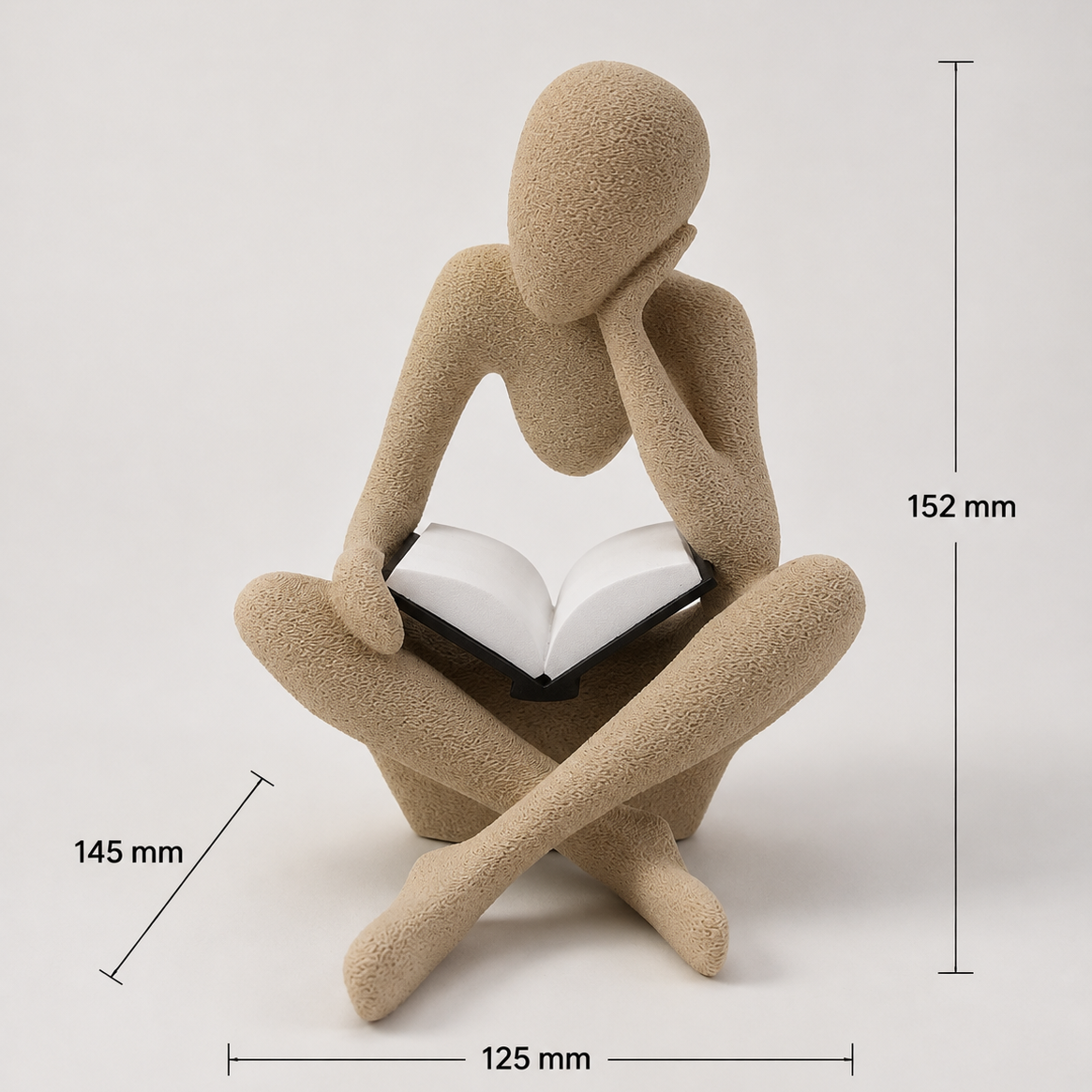 A beige sculptural figurine of a seated person holding an open book, shown on a light gray background with dimension callouts indicating 152 mm height, 145 mm left side depth, and 125 mm width.