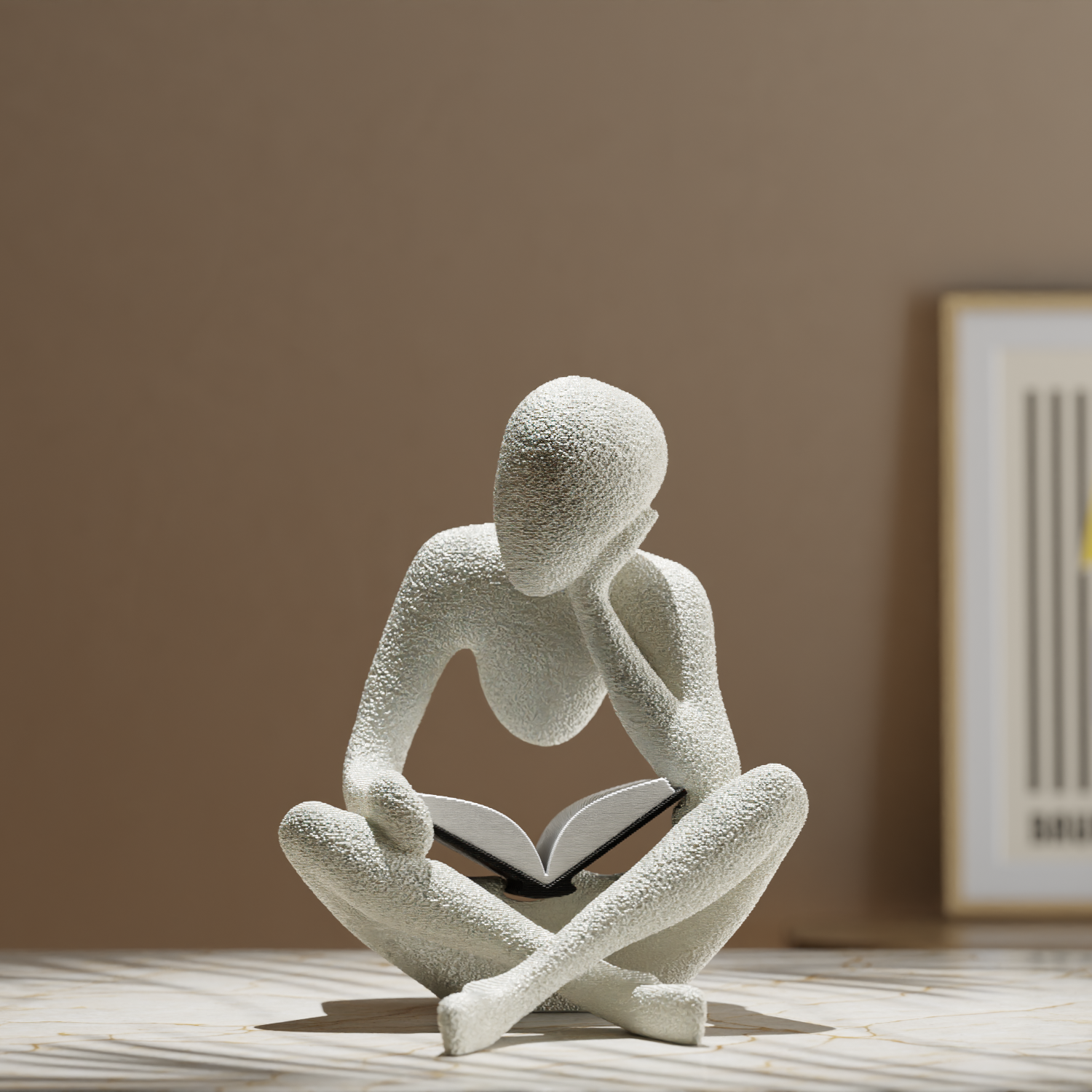 White abstract sculpture of a person reading a book on a wooden surface with a neutral background