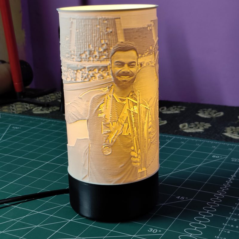 Litho Lamp in dark room, glowing with custom photo